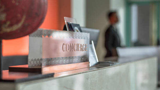 concierge service desk counter with hotel staff team working in front of reception hall for tourist business customer - hotel desk reception imagens e fotografias de stock