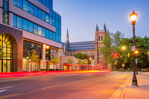 Stock photograph of a street in downtown London Ontario Canada with St Peter's Cathedral Basilica in the background at twilight blue hour.