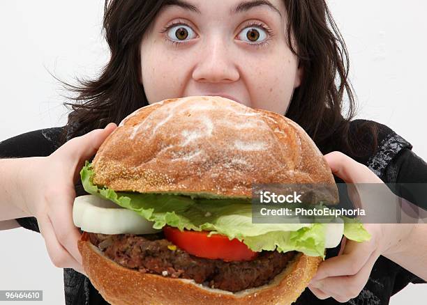 A Woman Getting Ready To Eat A Giant Hamburger Stock Photo - Download Image Now - Large, Biting, Eating