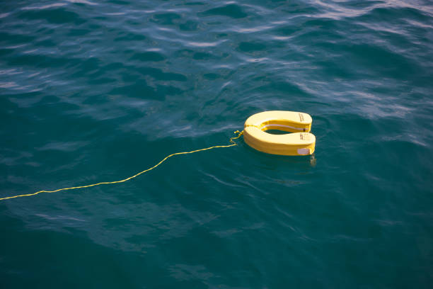 istock Yellow lifebuoys float on the sea 964654822