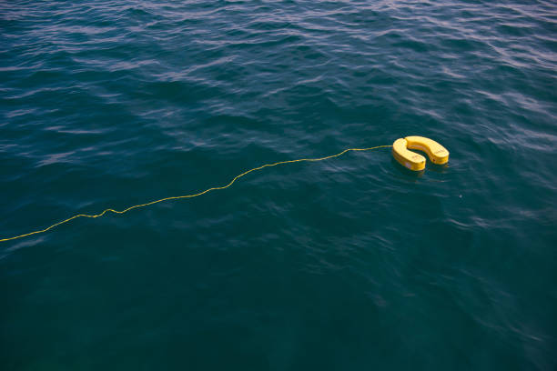istock Yellow lifebuoys float on the sea 964654878