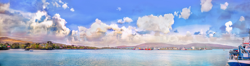 Panoramic landscape with cumulus clouds and ships in a county Kerry. Ireland.