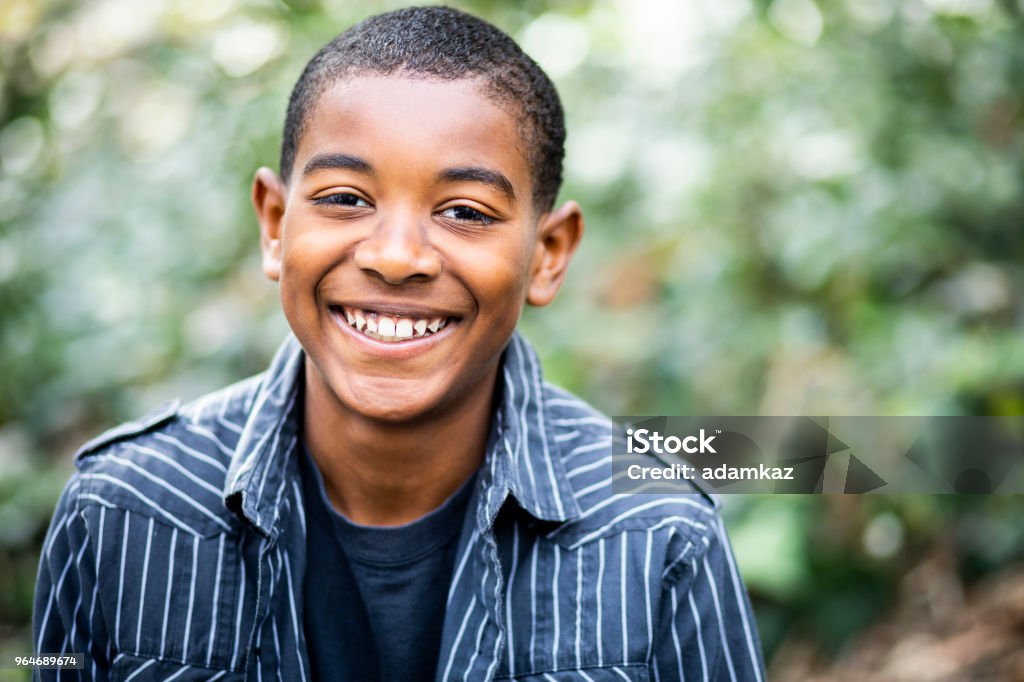 Young Black Boy Portrait Portrait of a young black boy smiling Teenager Stock Photo