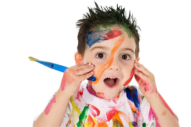 istock Young child covered in paint holding a paintbrush 96470511