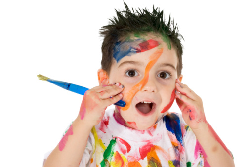 3 year old boy covered in paint.  Clipping path. Over white.