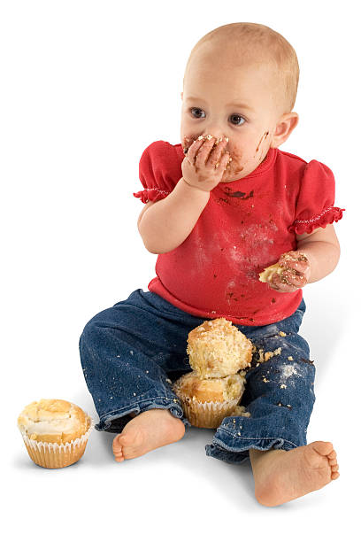 istock Baby Eating Muffins 96470527