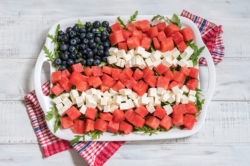 Patriotic American flag salad with blueberry, watermelon and feta on arugula