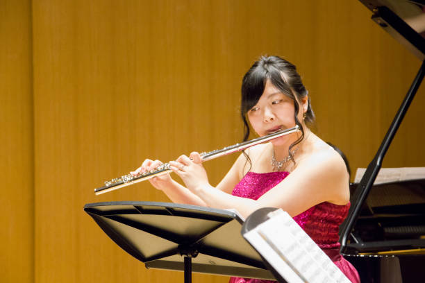 istock Woman Playing Flute in a Concert 964722208