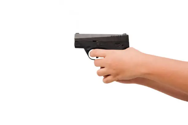 Woman hand with a gun on white background