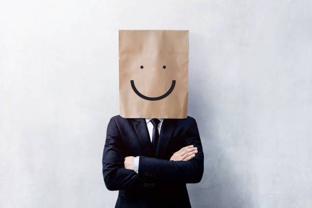 istock Customer Experience Concept, Portrait of Happy Businessman Client with Smiley Face Emotion on Paper Bag, Crossed arms and wearing Suit, Standing at the Concrete Wall 964728126