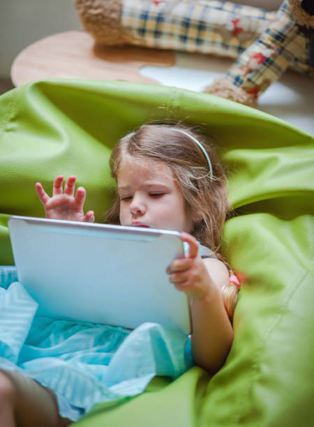 istock Little Girl Working On Her Digital Tablet 964728164