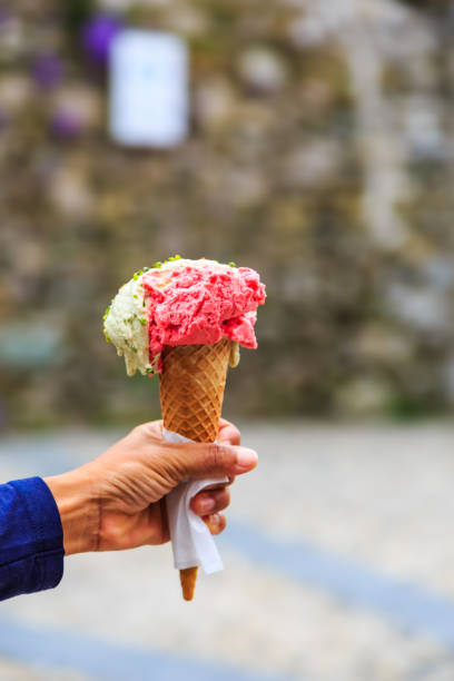 istock Cone of gelato in hand 964739160
