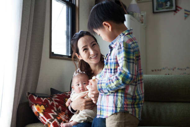 istock Mother, baby and young boy. 964739316