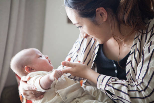 istock A baby resting with a mother hugged. 964741638
