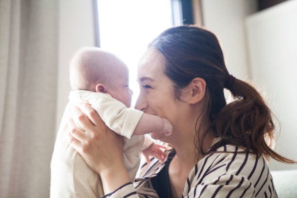 istock Mother looking at the baby's face. 964741682