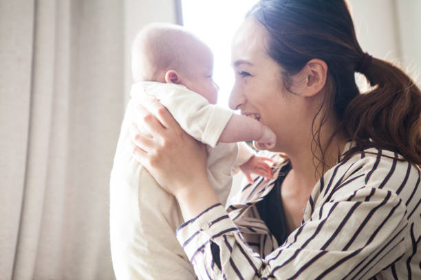 istock Mother looking at the baby's face. 964741764