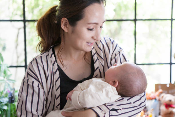 istock Mother looking at the baby's face. 964742582