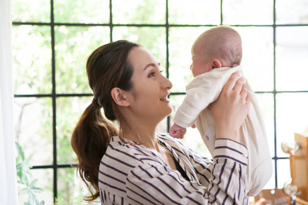 istock Mother looking at the baby's face. 964742686