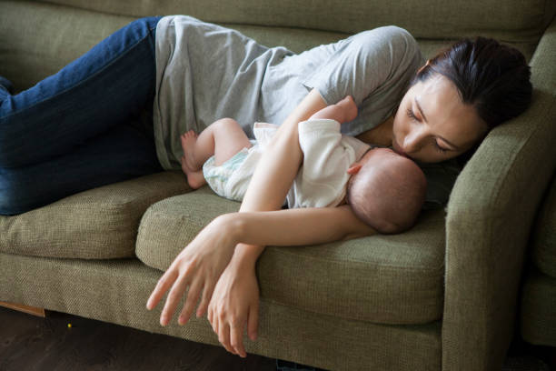 istock A baby sleeping with a mother who has an arm pillow. 964745346