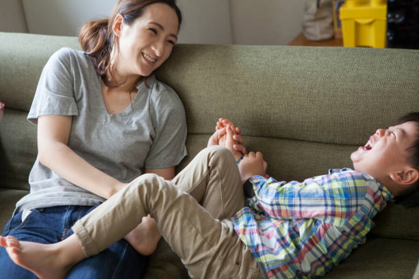 istock Children and mothers playing on the sofa. 964745636