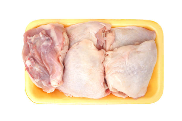 istock Raw chicken legs in a pack isolated on white background. Top view. Chicken thighs for cooking. 964745928