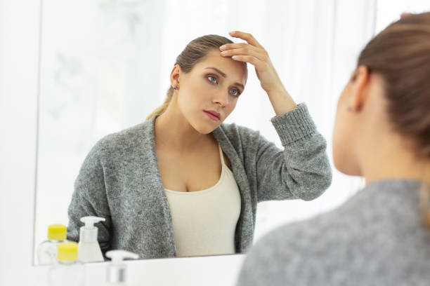 istock Serious concerned woman noticing wrinkle 964746440