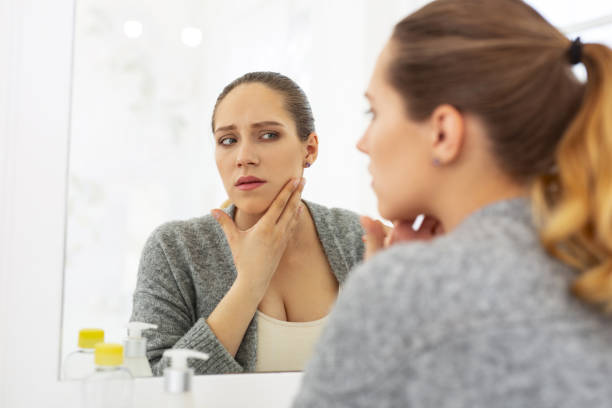 istock Sad attractive woman scrutinizing her face 964746694