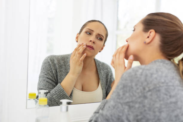 istock Concentrated pensive woman inspecting her face 964746728