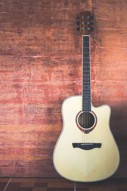 istock Guitar on wooden wall 964749382