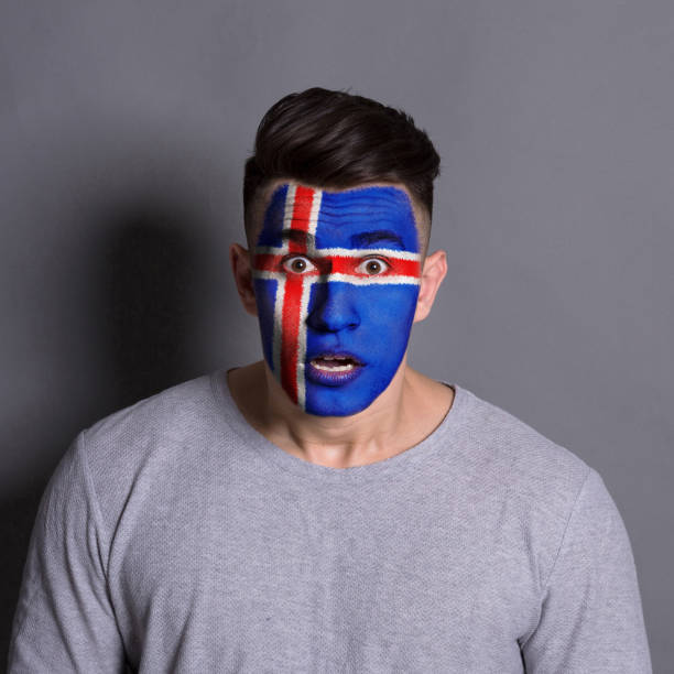 istock Young man with Iceland flag painted on his face 964749686