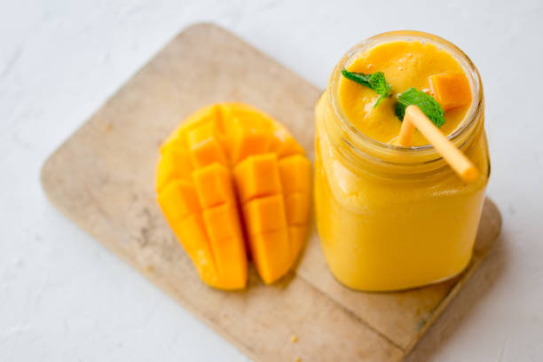 mango in a glass jar Mason on the old wooden background stock photo