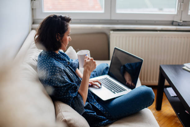 Cropped image of woman using laptop with blank screen
