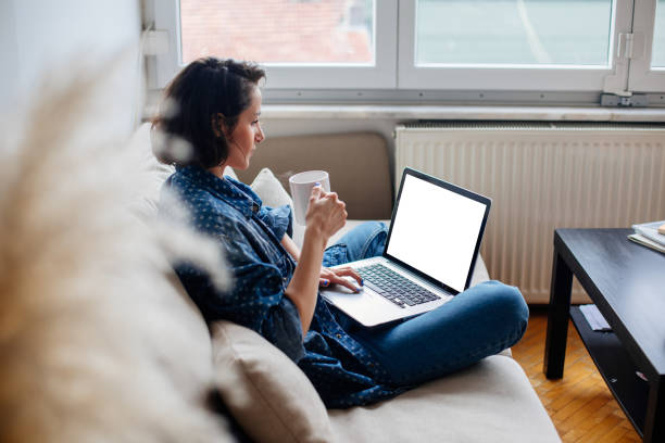 istock Cropped image of woman using laptop with blank screen 964762270
