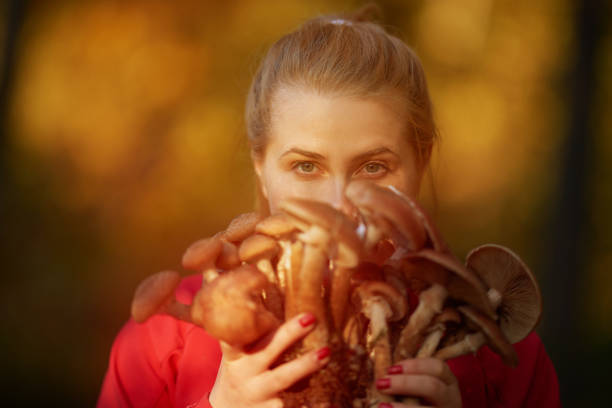 istock woman holding mushrooms 964762826