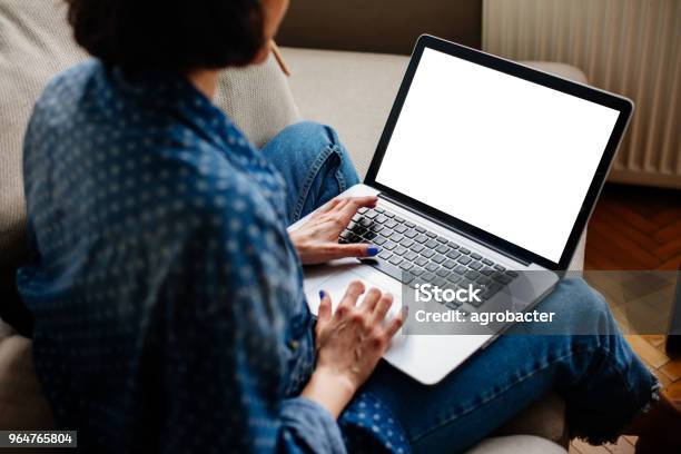 Cropped Image Of Woman Using Laptop With Blank Screen Stock Photo - Download Image Now