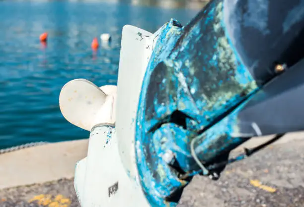 Old outboard with peeling paint. Selective focus.