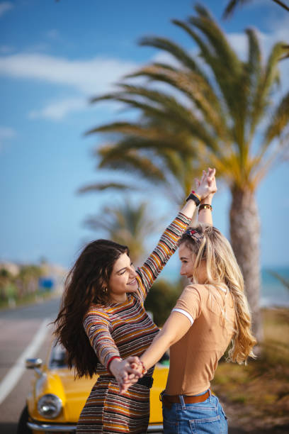 istock Young women being silly on tropical vacations road trip 964766856
