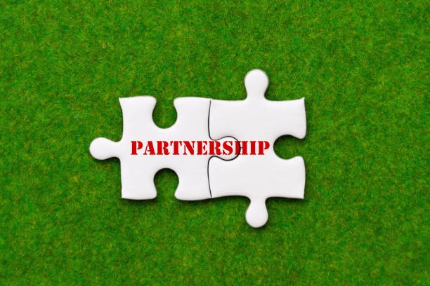 istock two connected jigsaw puzzle pieces with partnership woring 964769010
