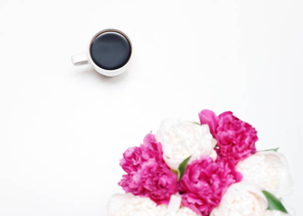istock Work place with cup coffee white pink peony flowers 964774868