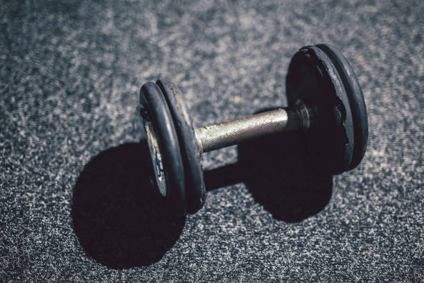 istock Dumbbells in gym on floor. 964775332