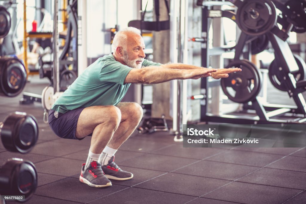 Exercise. Senior man working exercise at gym. Senior Adult Stock Photo