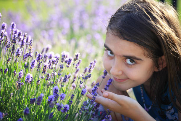 istock Relaxed girl smelling lavender flowers 964778440