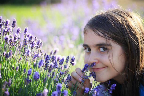 istock Relaxed girl smelling lavender flowers 964781412