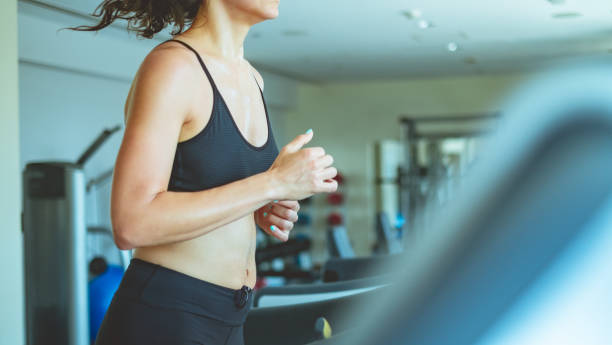 istock Side view of woman on treadmill 964782348