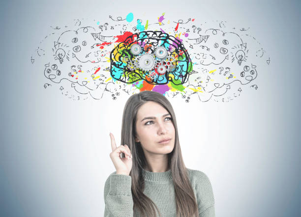 istock Thoughtful woman in green pointing up, cog brain 964782540