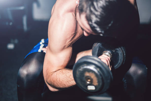 istock Young handsome man exercise in the gym. 964782882