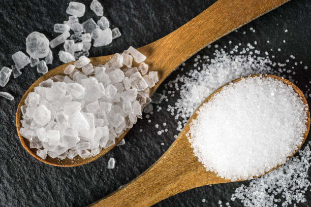 istock Different types of salt. Top view on two wooden spoons 964785610