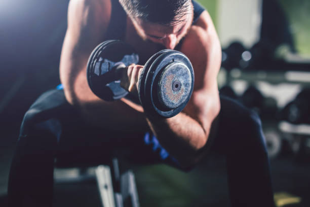 istock Young handsome man exercise in the gym. 964786128