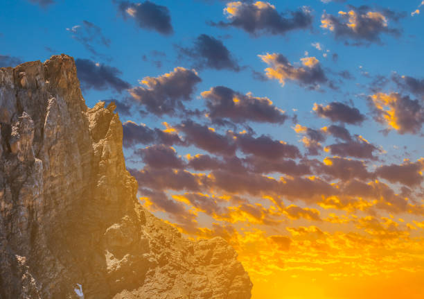 high rock slope on a sunset background