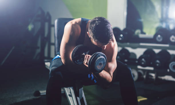 istock Young handsome man exercise in the gym. 964786264